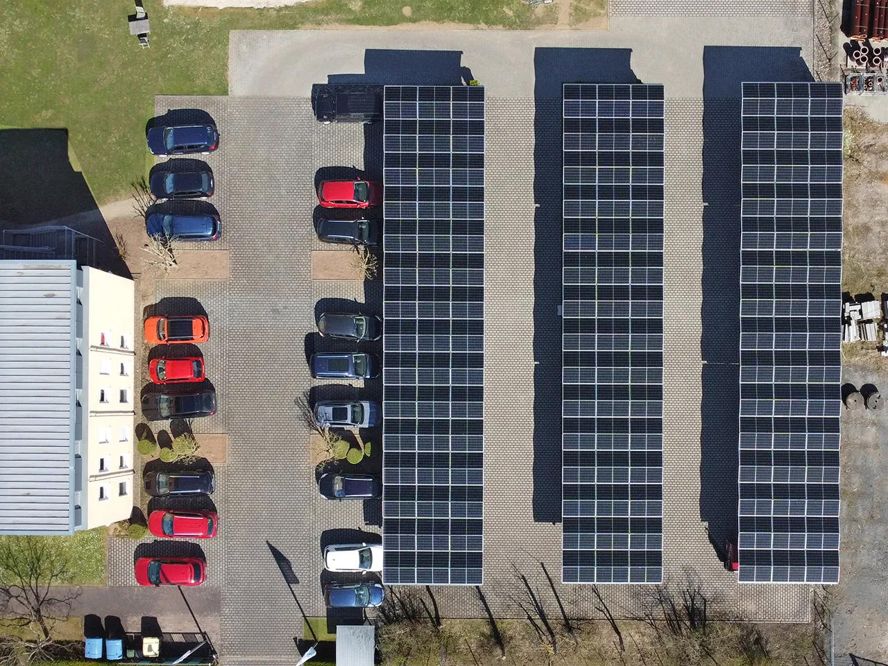 E-Auto beim Laden an einer Ladesäule unter einem Carport mit Solardach in Deutschland